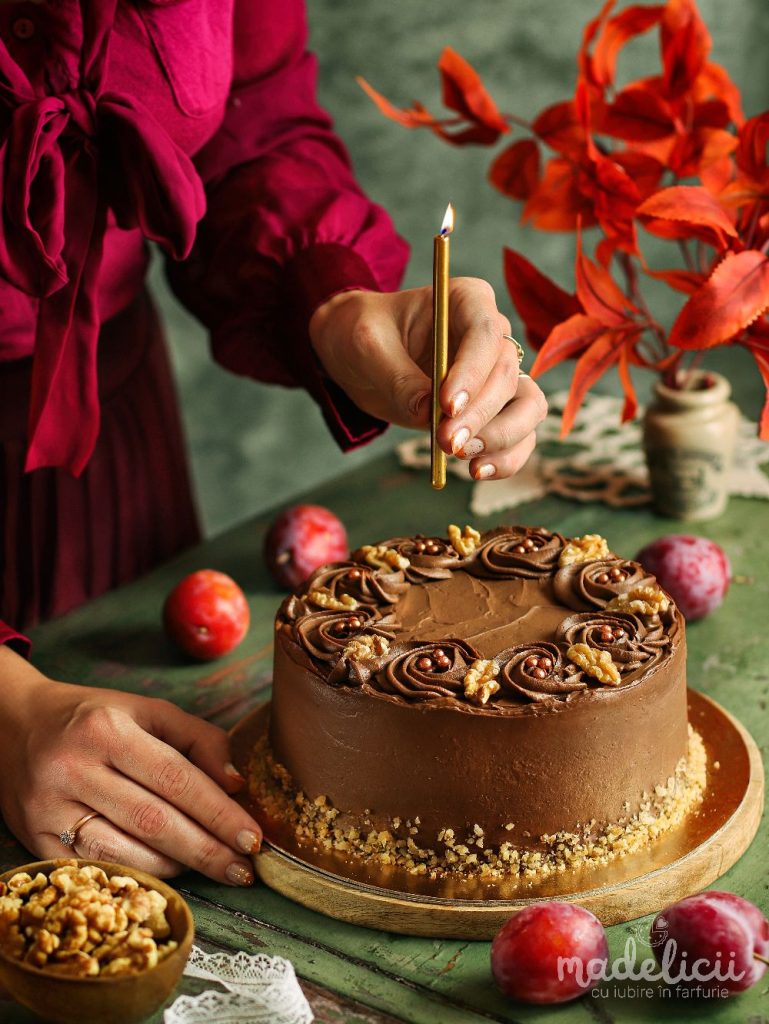 ort cu nuca, ciocolata si jeleu de prune, decorat elegant, servit pe masa de toamna